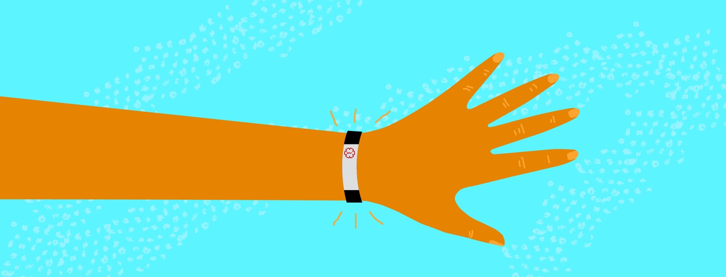 An arm, person is wearing medical alert bracelet