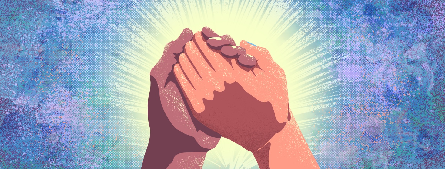 Two hands clasped and raised with light shining behind them.