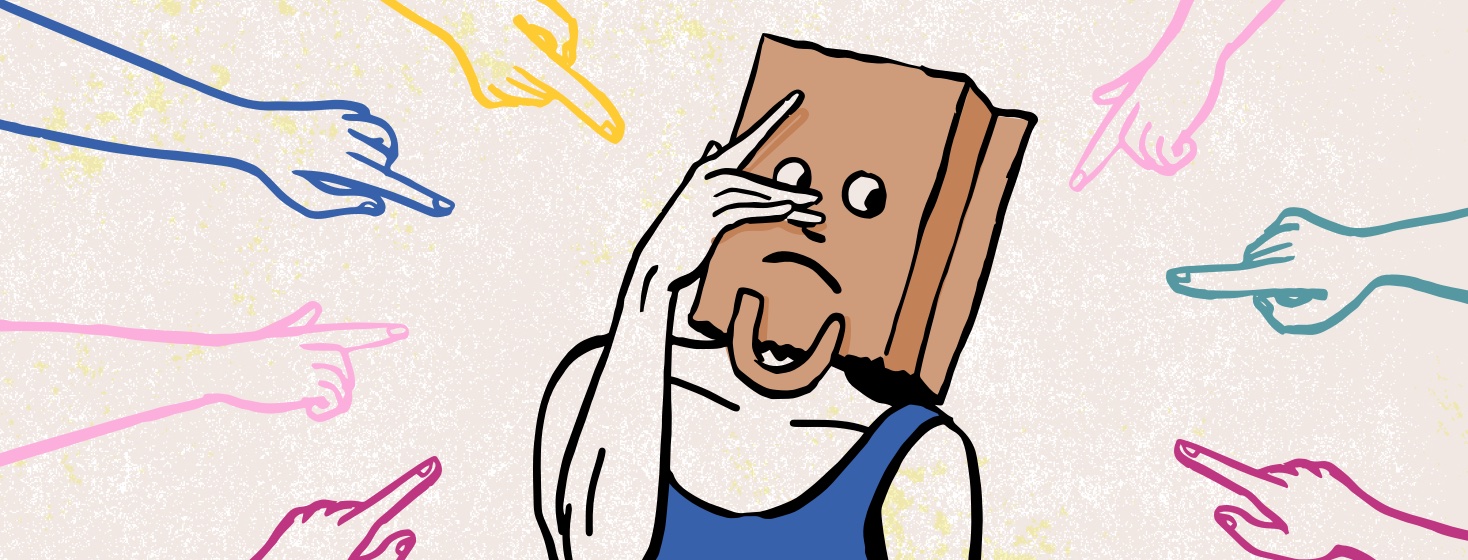 Hands pointed at a person wearing a brown paper bag.