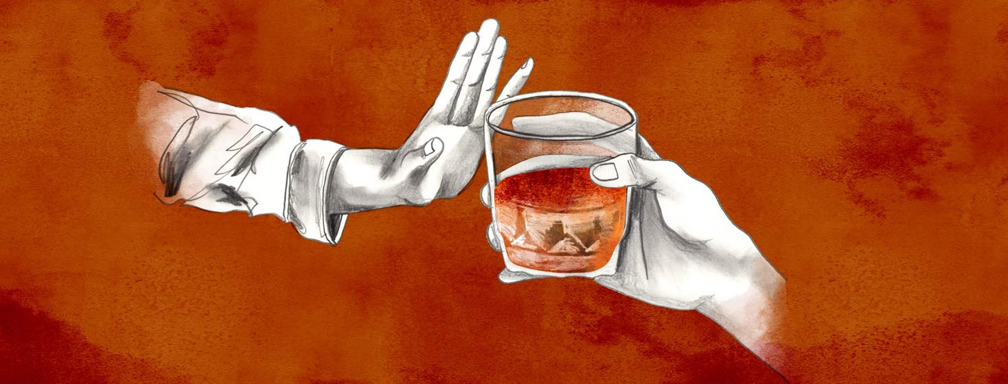 a hand pushes away a cocktail