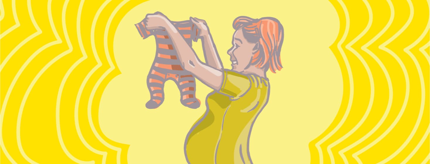 a pregnant mom holds up a tiny onesie in front of a yellow background