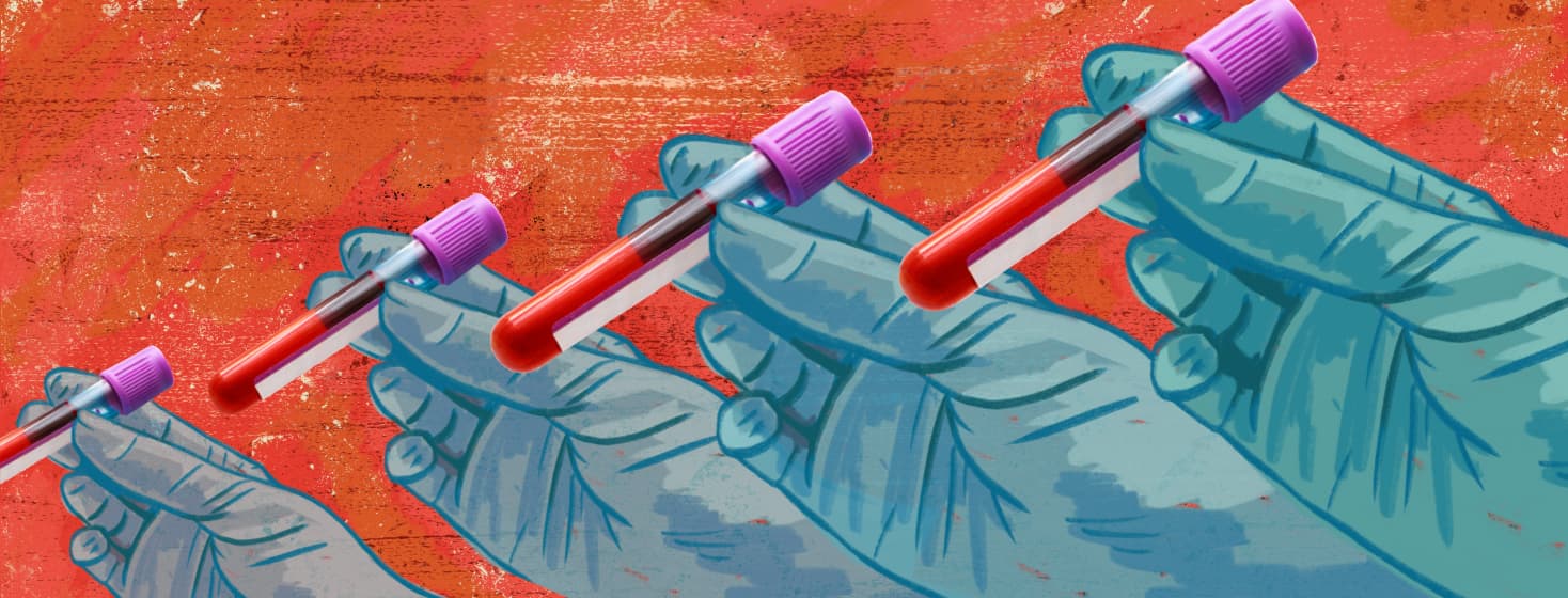blue gloved hands holding test tubes of blood