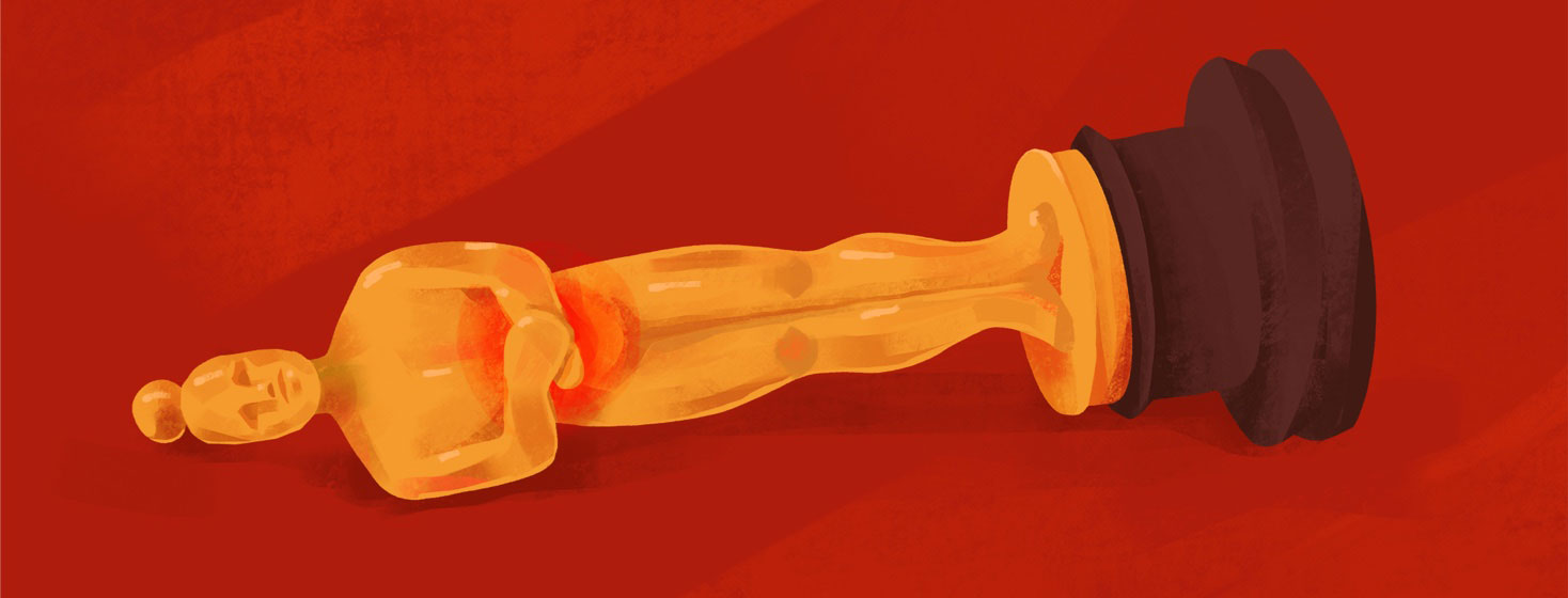 An Oscar statue lying on its side with a red stomach