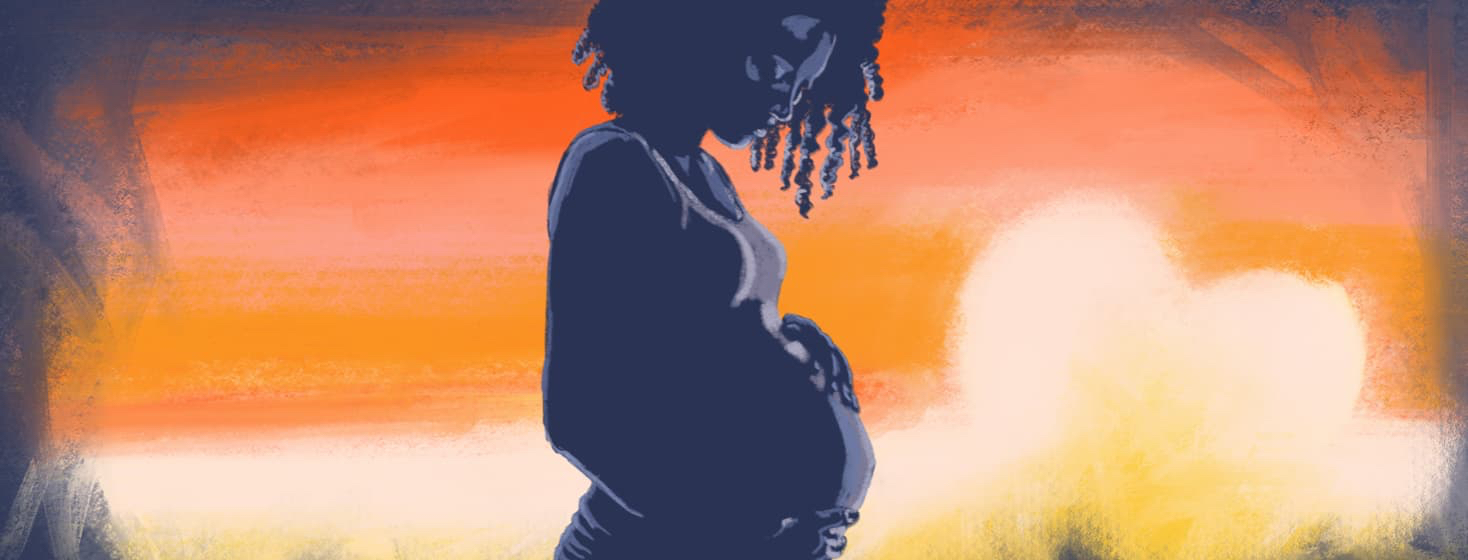 A woman looks anxiously down at her pregnant stomach